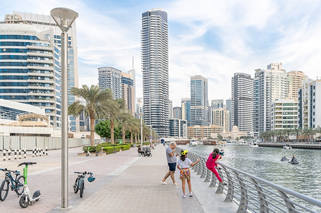 man with daughters on promenade in dubai